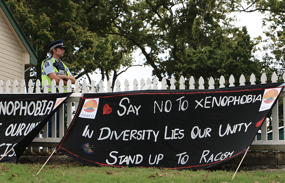 Speakers at the Auckland Domain vigil stand up against racism and xenophobia. Photo: Irra Lee