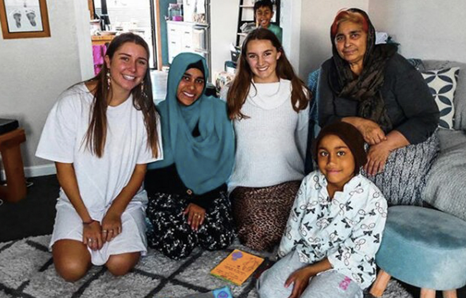 Creator of Cards for Community, Maddie Mason, with a South Island Muslim family who invited her into their home to create cards with them. Photo: Supplied