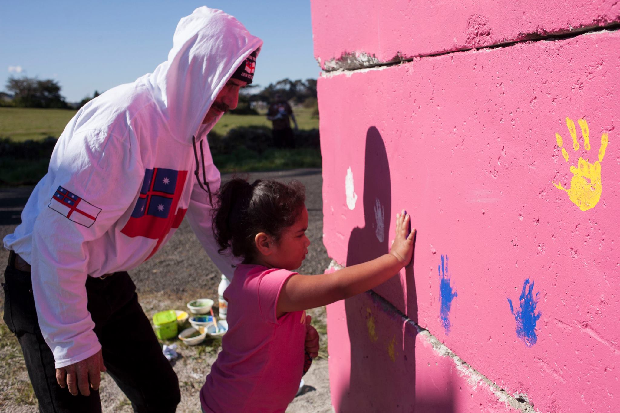 Dad and daughter finger painting walls