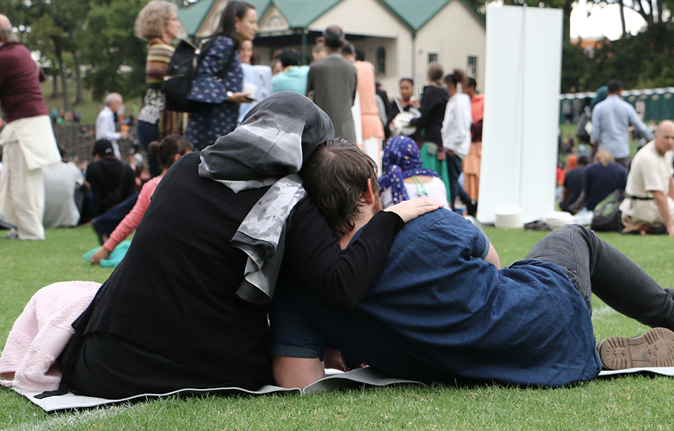 A hug for comfort among a sea of thousands gathering in Auckland Domain to pay their respects to the victims of the Christchurch terror attacks. Photo: Irra Lee